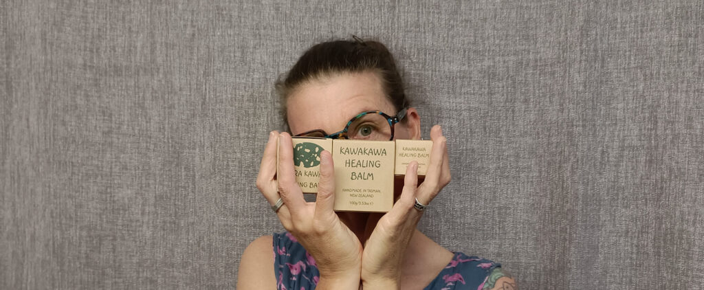 Kara hiding behind Kawakawa Healing Balm Kara hiding behind Kawakawa Healing Balm